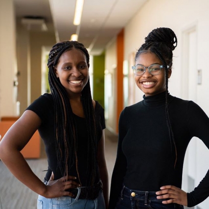 two students standing side-by-side.