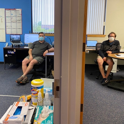 two men sitting in adjacent offices.