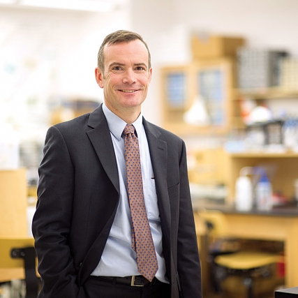 reseacher posing in lab.