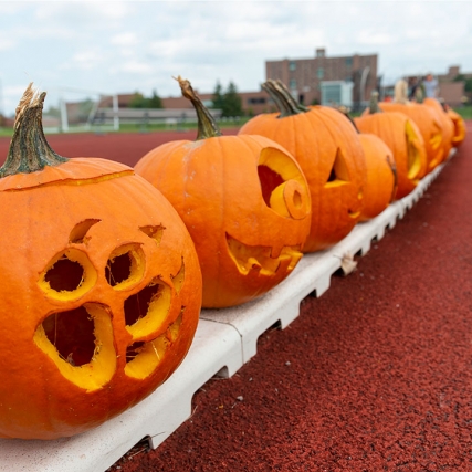 jack-o-lanterns lined up along an outdoor track.
