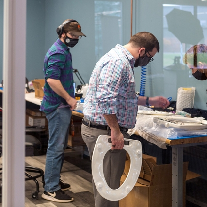 people working on toilet seat prototypes.