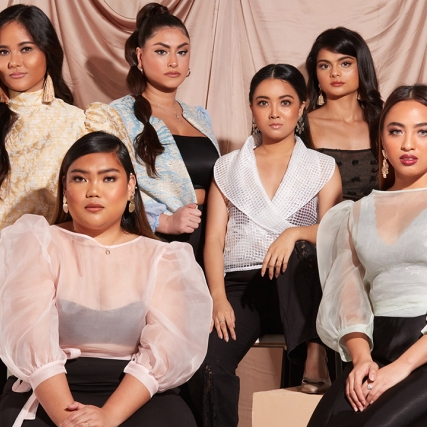 six women modeling clothes.