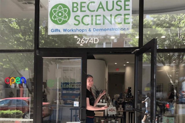 storefront with a sign for Because Science, gifts, workshops and demonstrations.