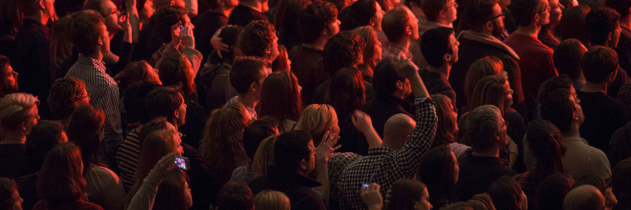 a dark images of many people at an event