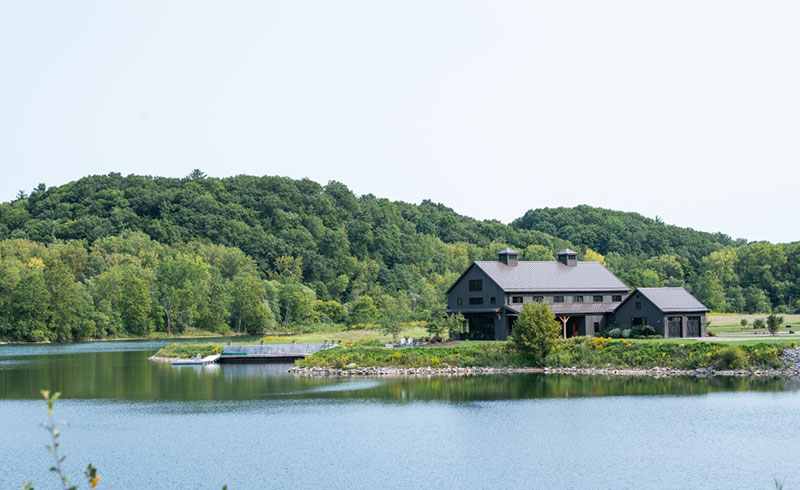 the Tait Preserve with mountains, a cabin, and a lake