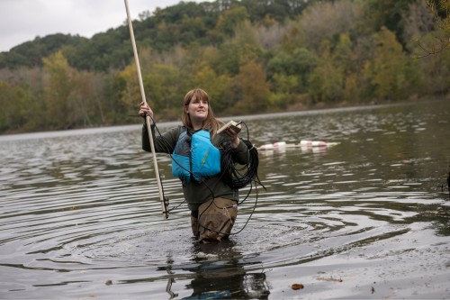 a person in a lake with scientific equipment