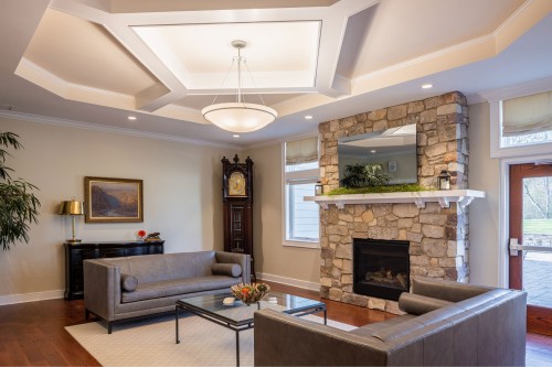 a fireplace lounge area inside the Lobozzo Alumni House