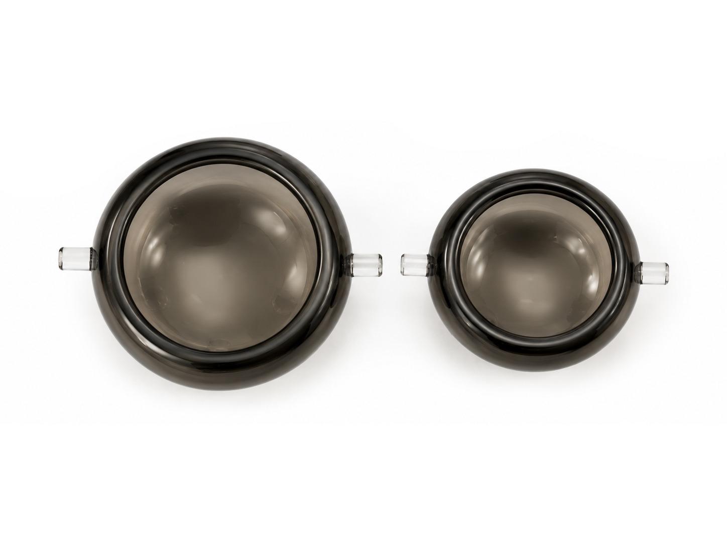 Top view of two dark glass Origins bowls with side handles.