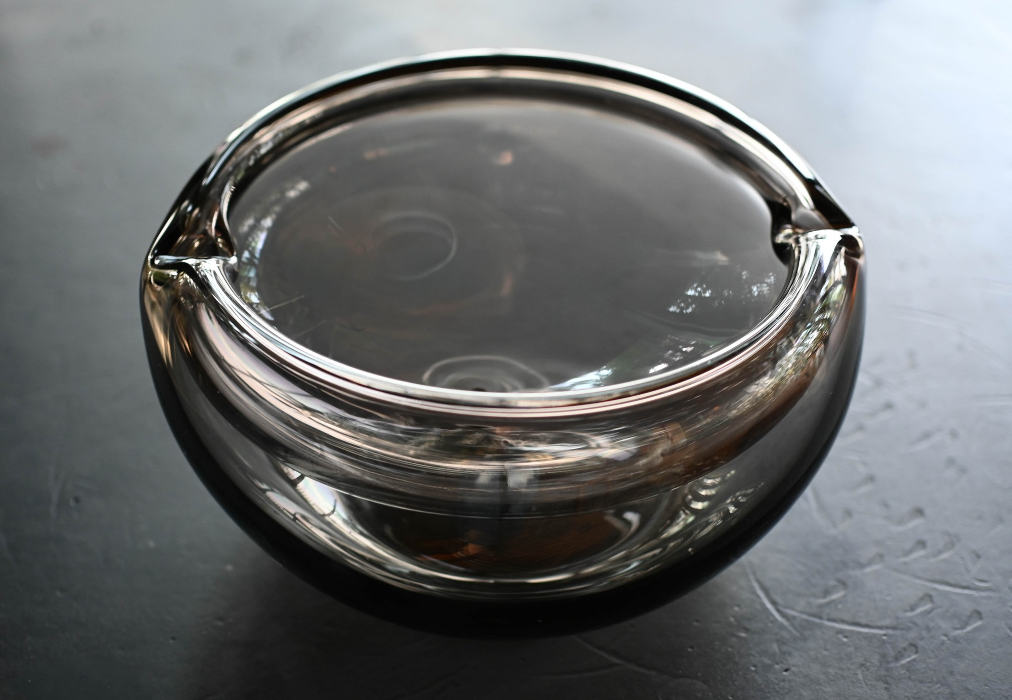 Double-walled glass bowl with notches in its rim.