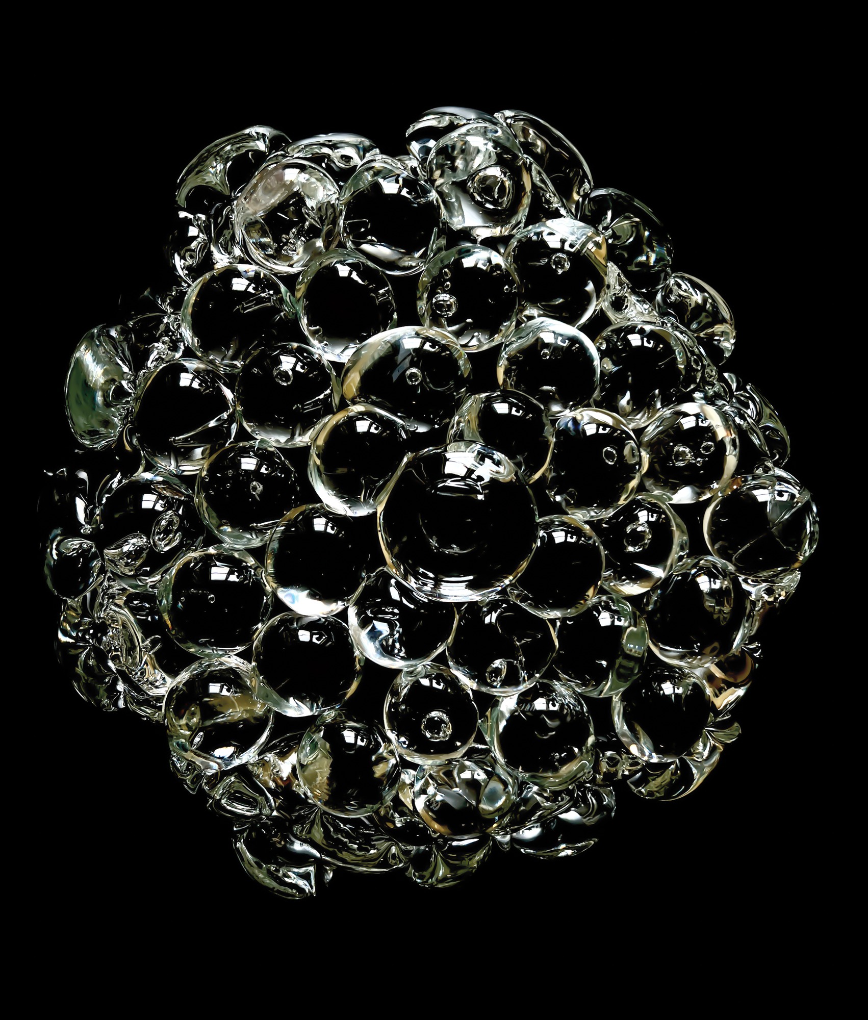 Detail of rounded glass elements against a black background.