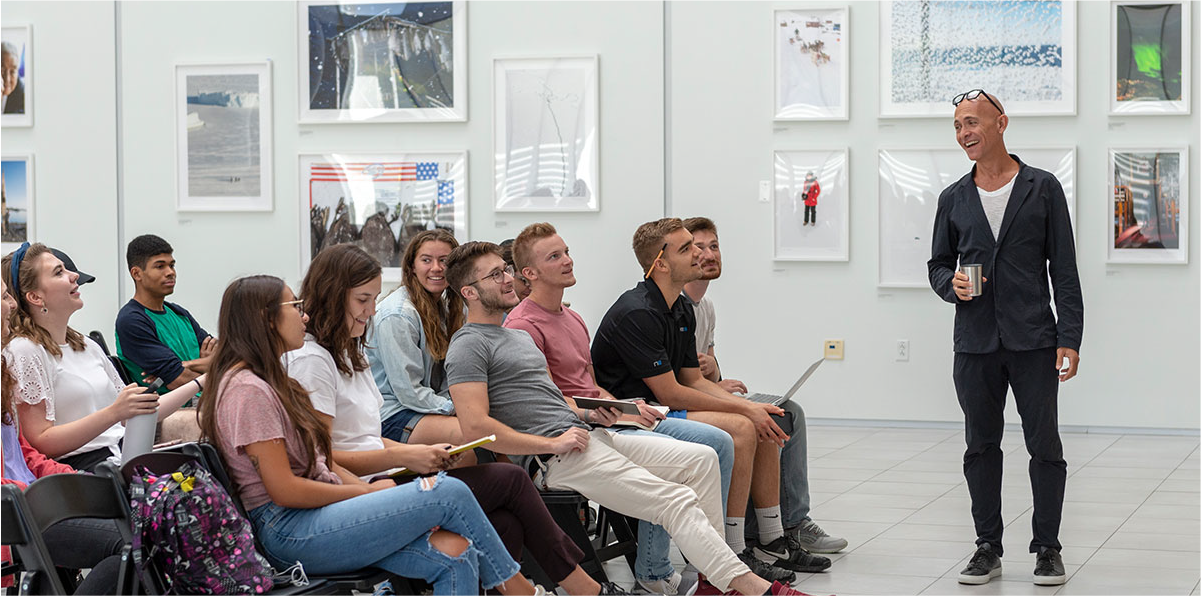 Josh Owen in front of students in the Vignelli Center Gallery