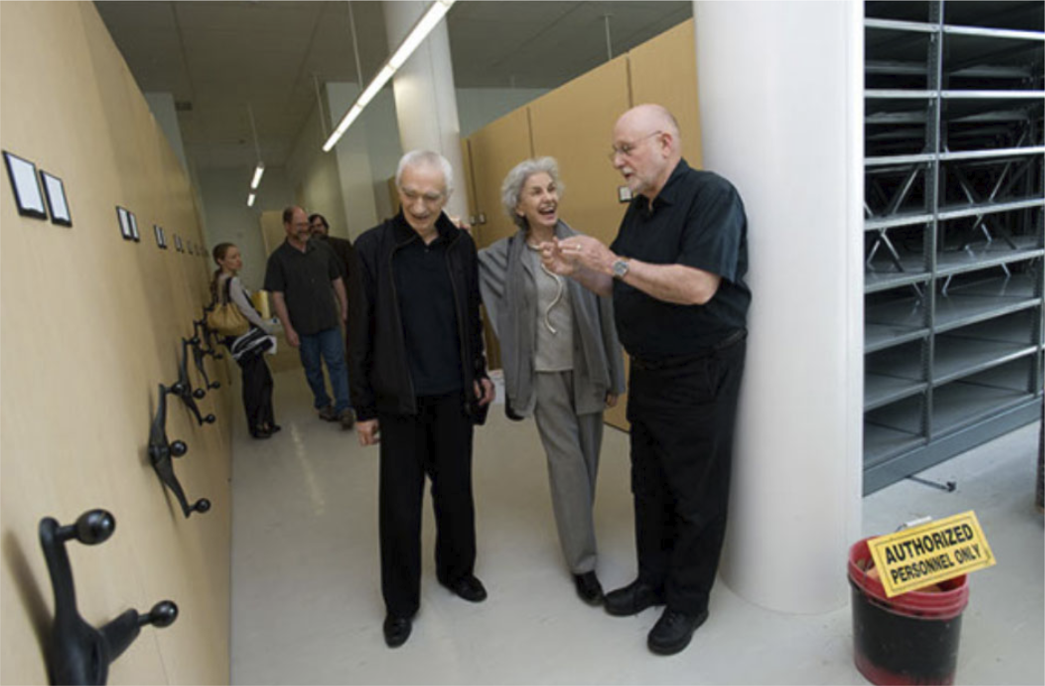 Massimo and Lella Vignelli with R. Roger Remington standing in the Vignelli Archives