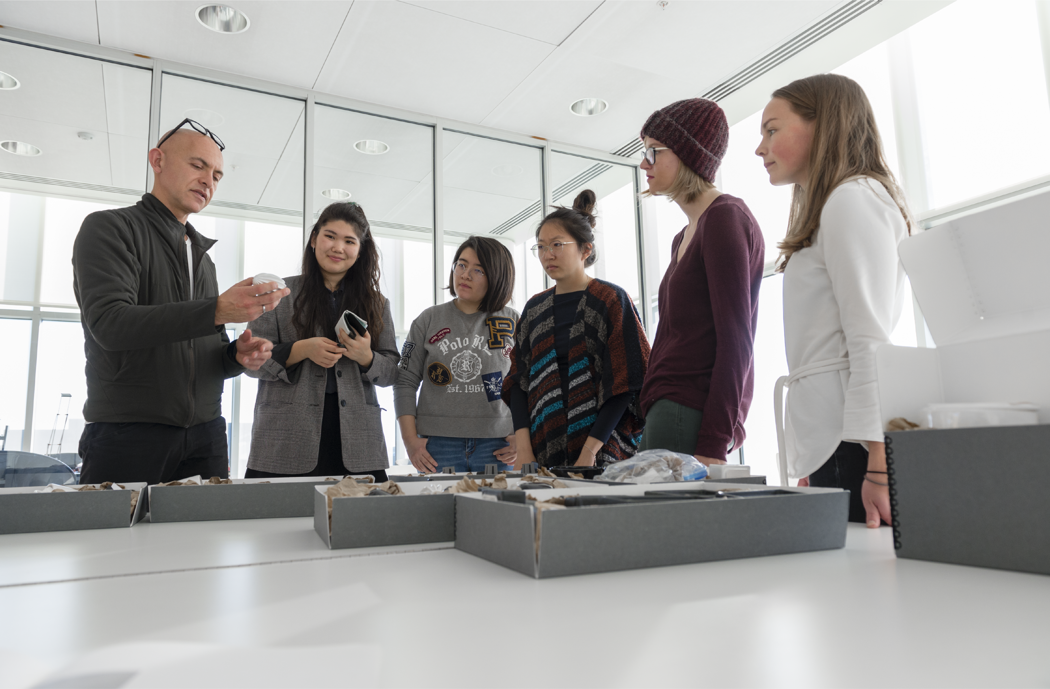 Group of students standing looking at professor Josh Owen and the Vignelli Archive