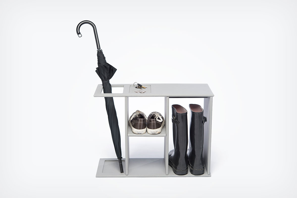 The Hello Bench with keys, an umbrella, shoes, and boots stored in and on it