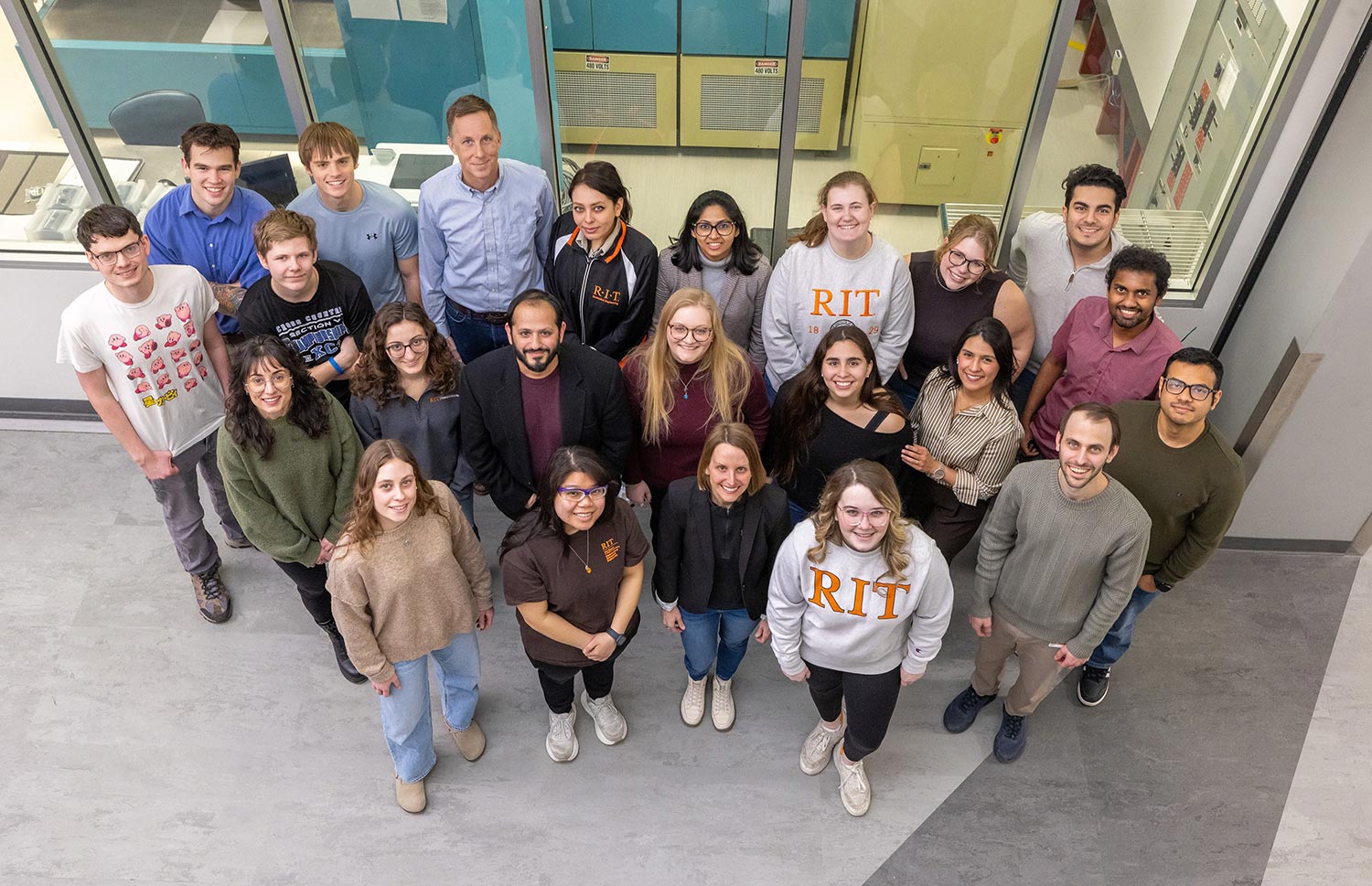 aerial view of a group of researchers outside of a lab.