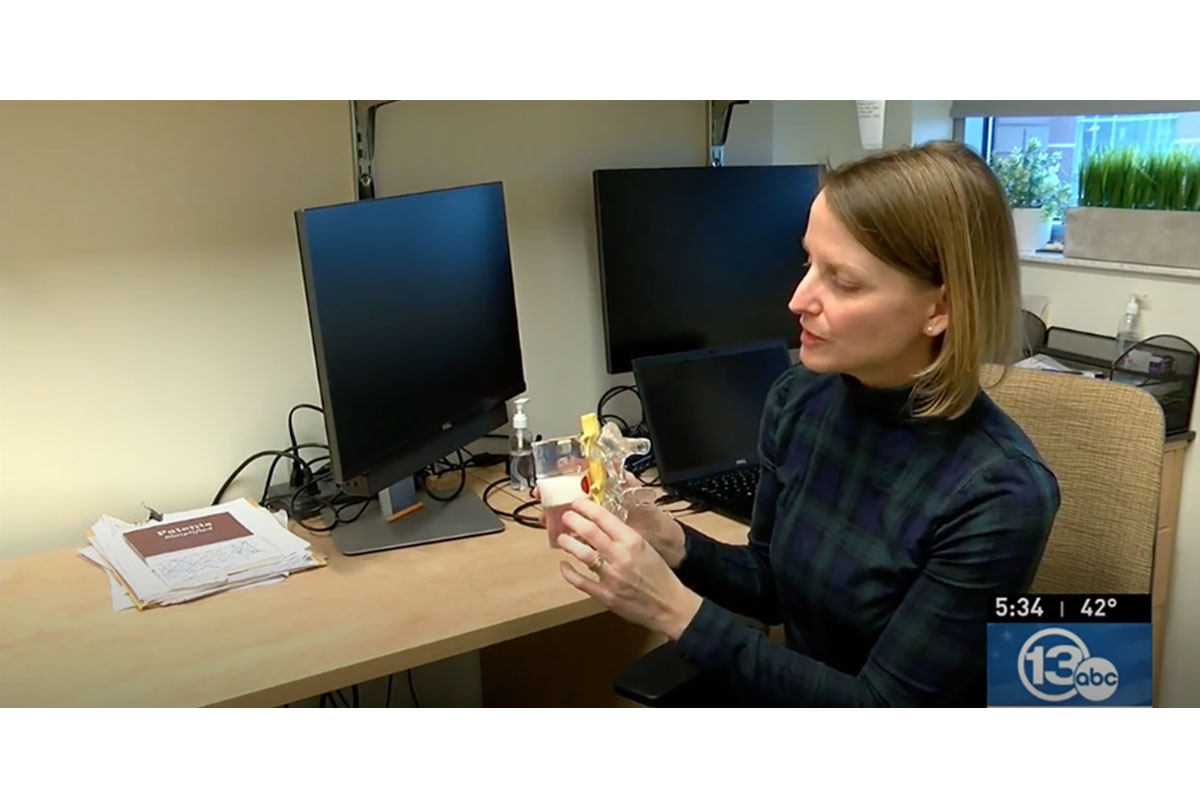 Karin with spine model and computer monitors.