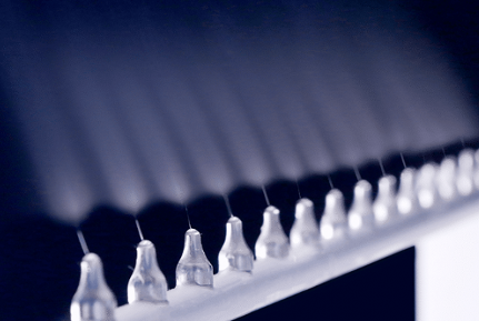 a machine with many nozzles lined up.