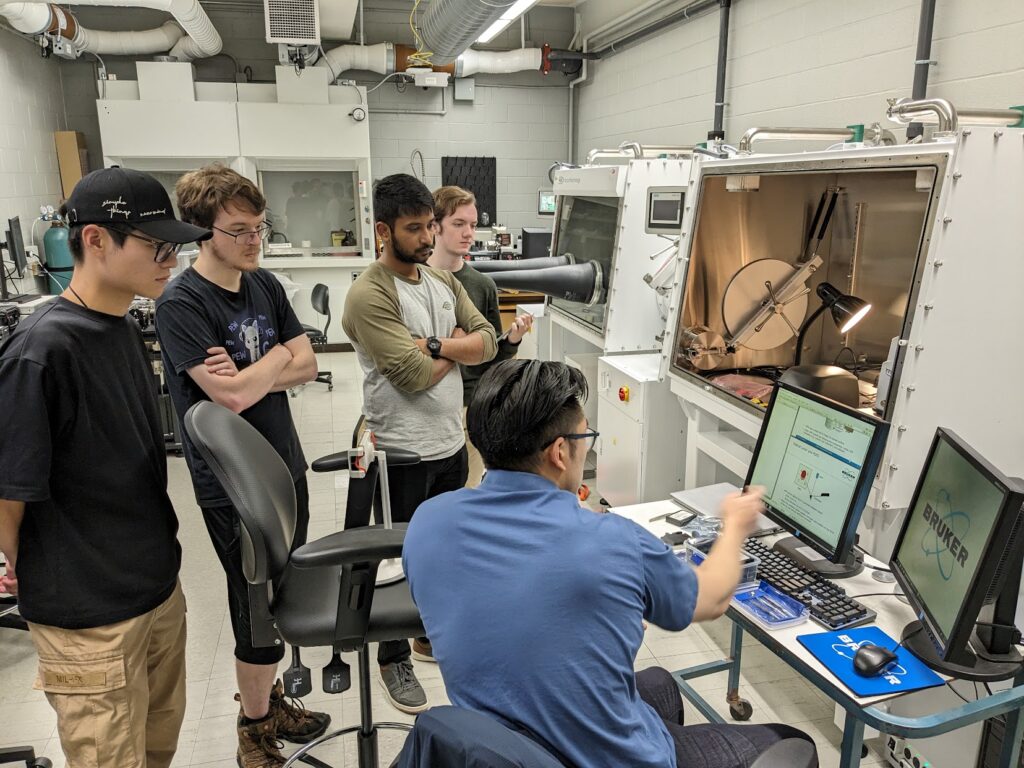 Xu Group members gathered around a Bruker Atomic Force Microscope during lab training.