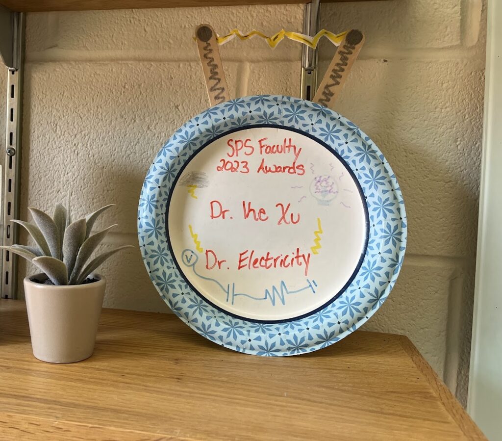 Decorative plate labeled SPS Faculty 2023 Award for Dr. Ke Xu, also called Dr. Electricity.