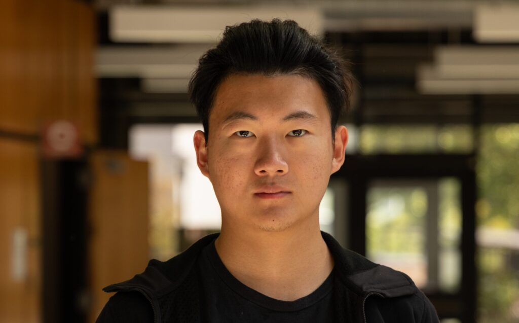 Portrait of Steve in an indoor campus setting.