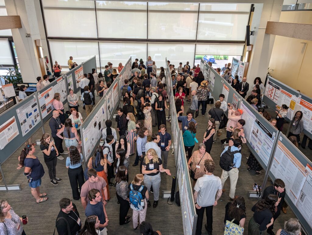 Crowded RIT Undergraduate Research Symposium poster session viewed from above.