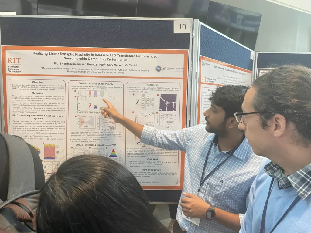 Nithil explaining a research poster to attendees at a conference poster session.