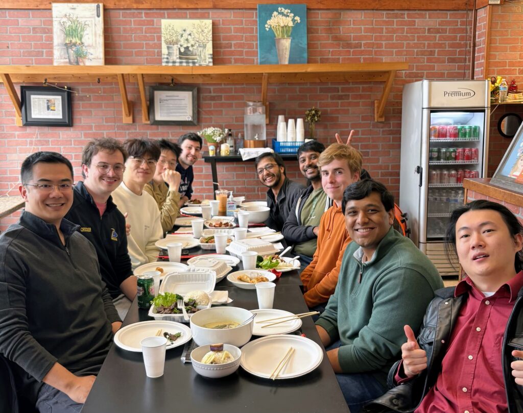 Xu Group members seated at a restaurant table, celebrating the end of the semester with a shared meal.