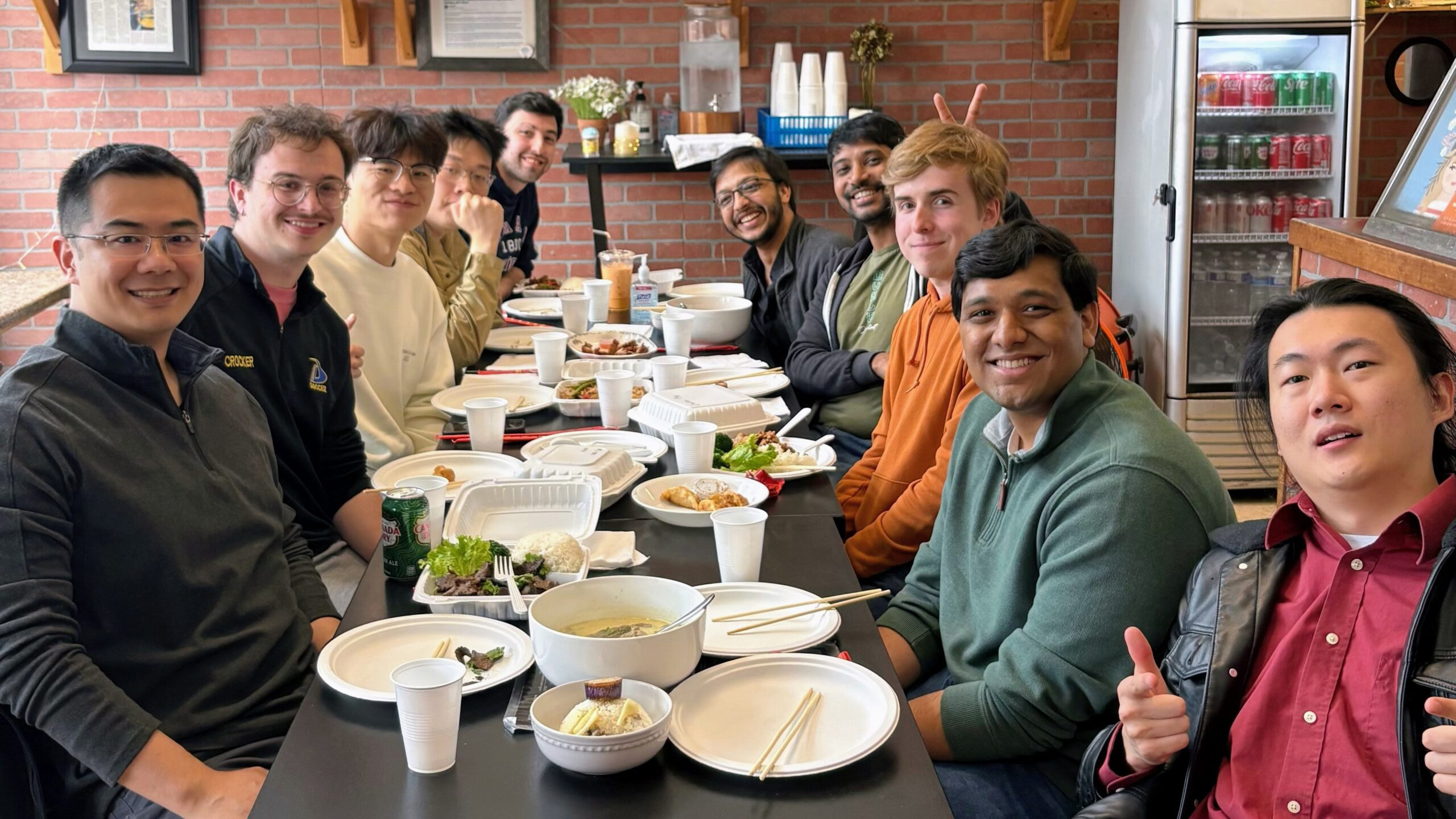 2026 Xu Group members seated together around a restaurant table during a group meal.
